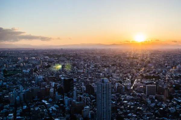 The setting sun above a vast city skyline