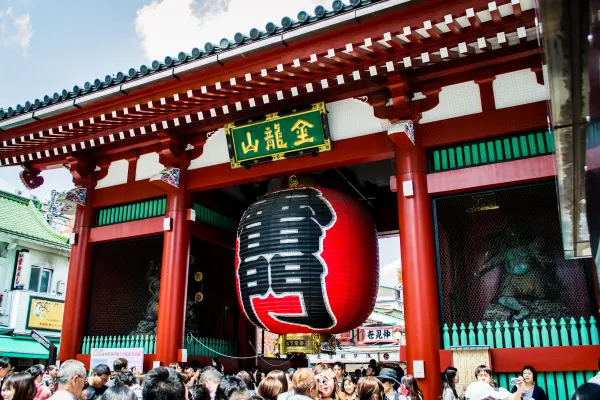 A giant red lantern hanging beneath a temple gate