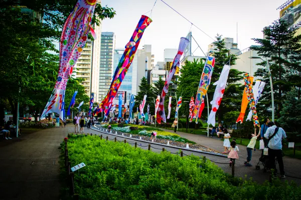 Colourful carp streamers flying above a green city park