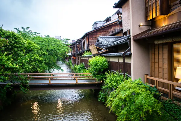 A narrow canal flowing beneath small bridges and traditional houses