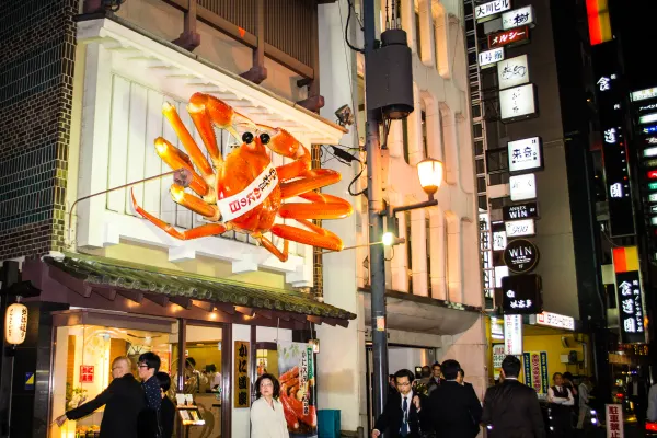 A giant orange crab sign above a brightly lit restaurant