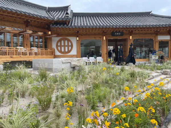 Traditional wooden architecture above a garden of wildflowers