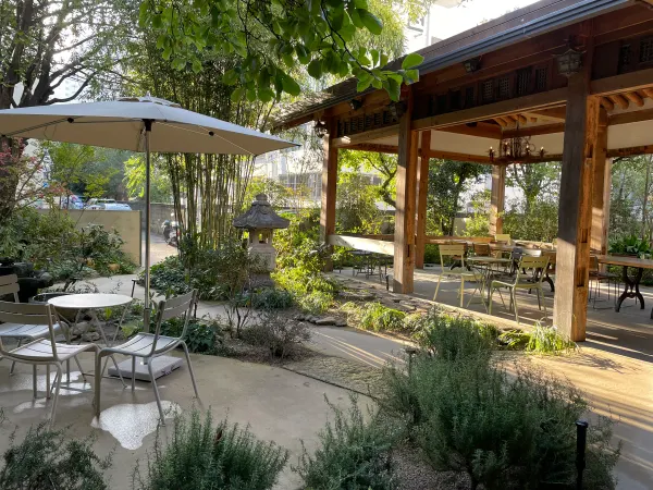 A quiet garden cafe among bamboo and traditional wooden buildings