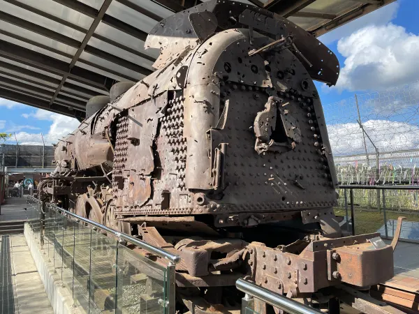 A rusted steam locomotive beneath a bright sky near the DMZ