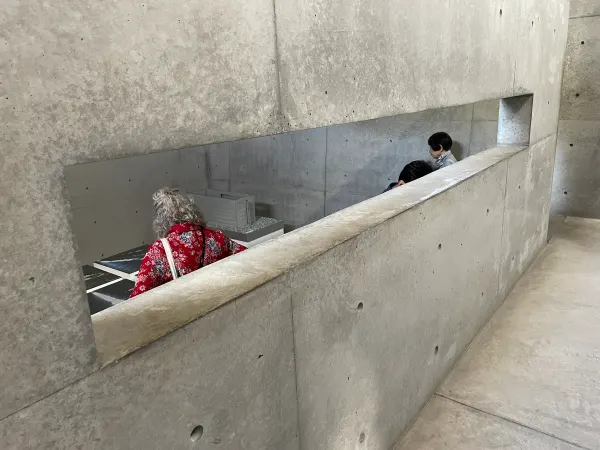 Visitors moving through intersecting concrete ramps