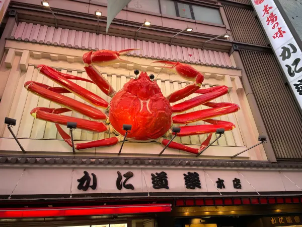 A giant red crab mounted above a restaurant entrance
