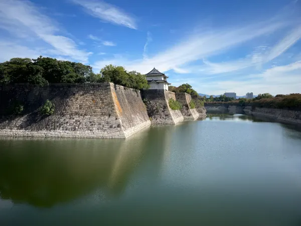Stone castle walls reflected in the moat
