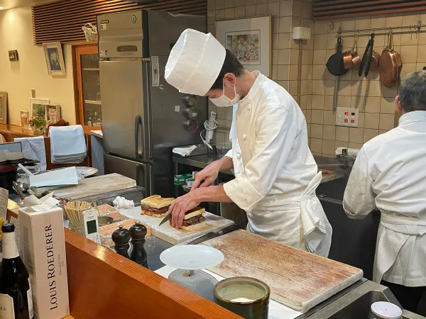A chef preparing food behind a counter