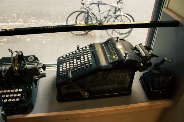 Antique typewriters beside a bookshop window