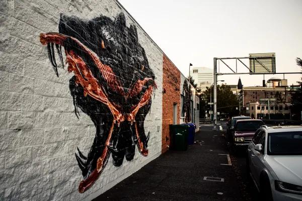 A large animal mural on a brick wall