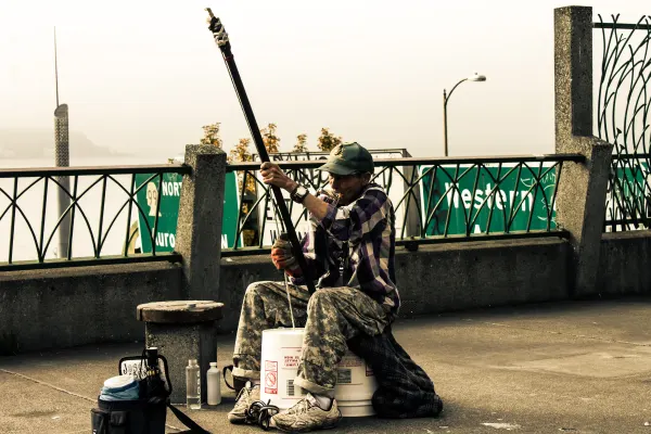 A street musician playing beside the waterfront