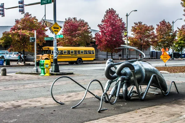 A metal octopus sculpture beside an autumn street
