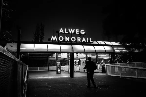 The illuminated Alweg Monorail entrance at night