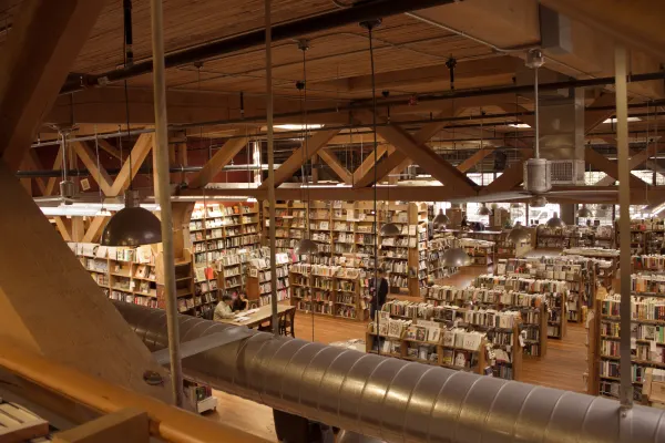 Timber beams above a bookshop full of shelves