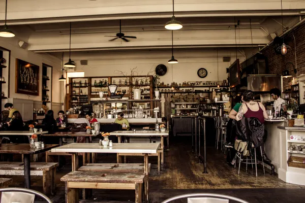 Tables and chairs inside a neighbourhood cafe