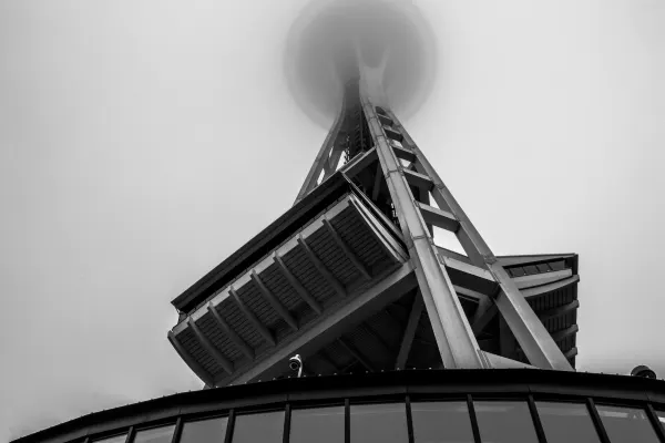 The Space Needle rising diagonally into low cloud