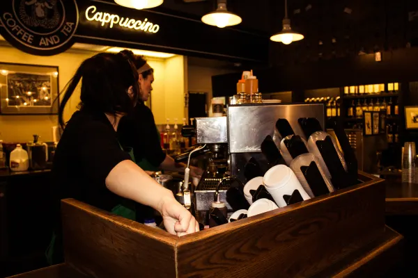 A barista working behind a coffee counter