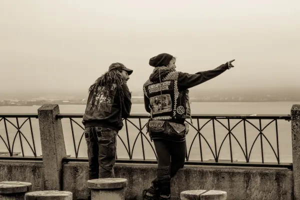 Two figures looking out over the waterfront