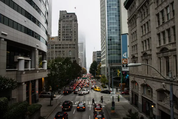 Traffic descending a Seattle street between tall buildings
