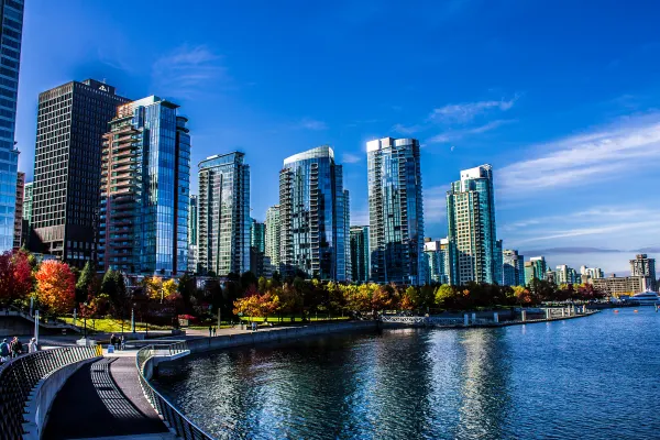 Vancouver towers reflected beside the waterfront promenade