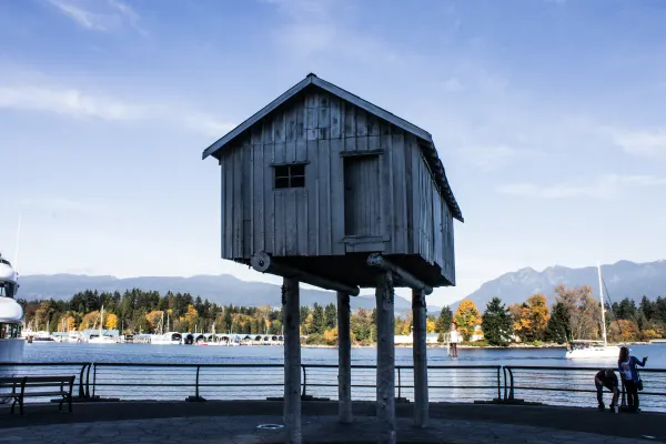 A small house-shaped sculpture raised above the waterfront
