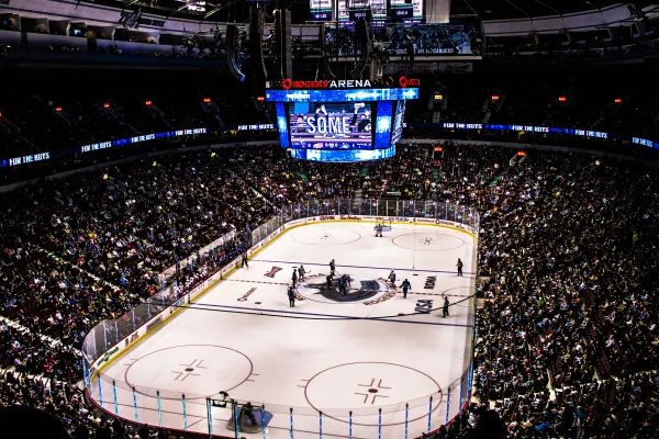 An ice hockey game inside a packed arena