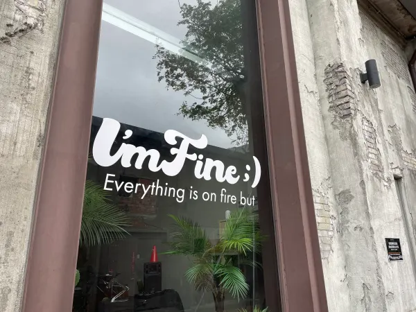 A café window with an illustrated face and the words I’m Fine