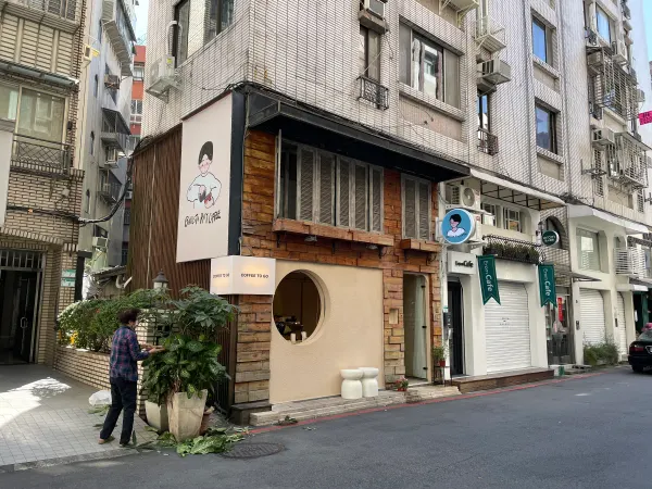 A small corner shop beneath weathered apartment façades