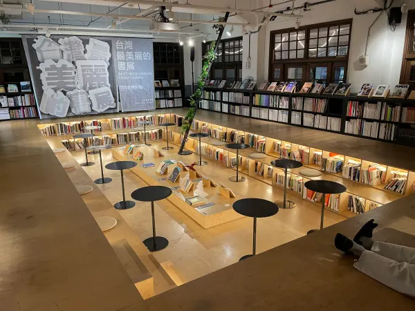 Lights and reading tables across tiered bookstore floors